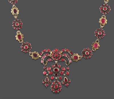 Lot 2214 - A Garnet and Red Stone Necklace, the central panel formed of a bow motif suspends a scroll motif to