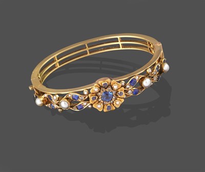 Lot 2215 - A Sapphire, Diamond and Split Pearl Bangle, the central cluster formed of a cushion cut...