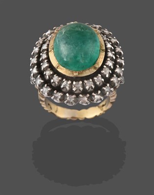 Lot 2216 - An Indian Emerald and Diamond Cluster Ring, the oval cabochon emerald in a yellow collet...