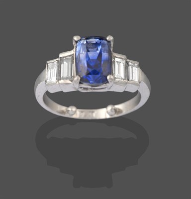 Lot 2227 - A Sapphire and Diamond Five Stone Ring, the central cushion cut sapphire in a white four claw...