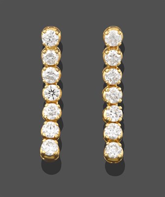 Lot 2250 - A Pair of 18 Carat Gold Diamond Drop Earrings, seven articulated round brilliant cut diamonds...
