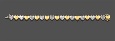 Lot 2255 - A Diamond Bracelet, the ten yellow plain polished heart shaped links alternate with ten white...