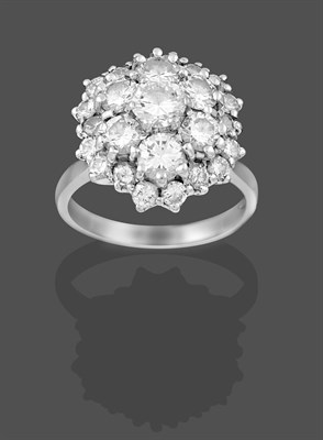 Lot 2256 - A Diamond Cluster Ring, the round brilliant cut diamond within two graduated stepped borders of...