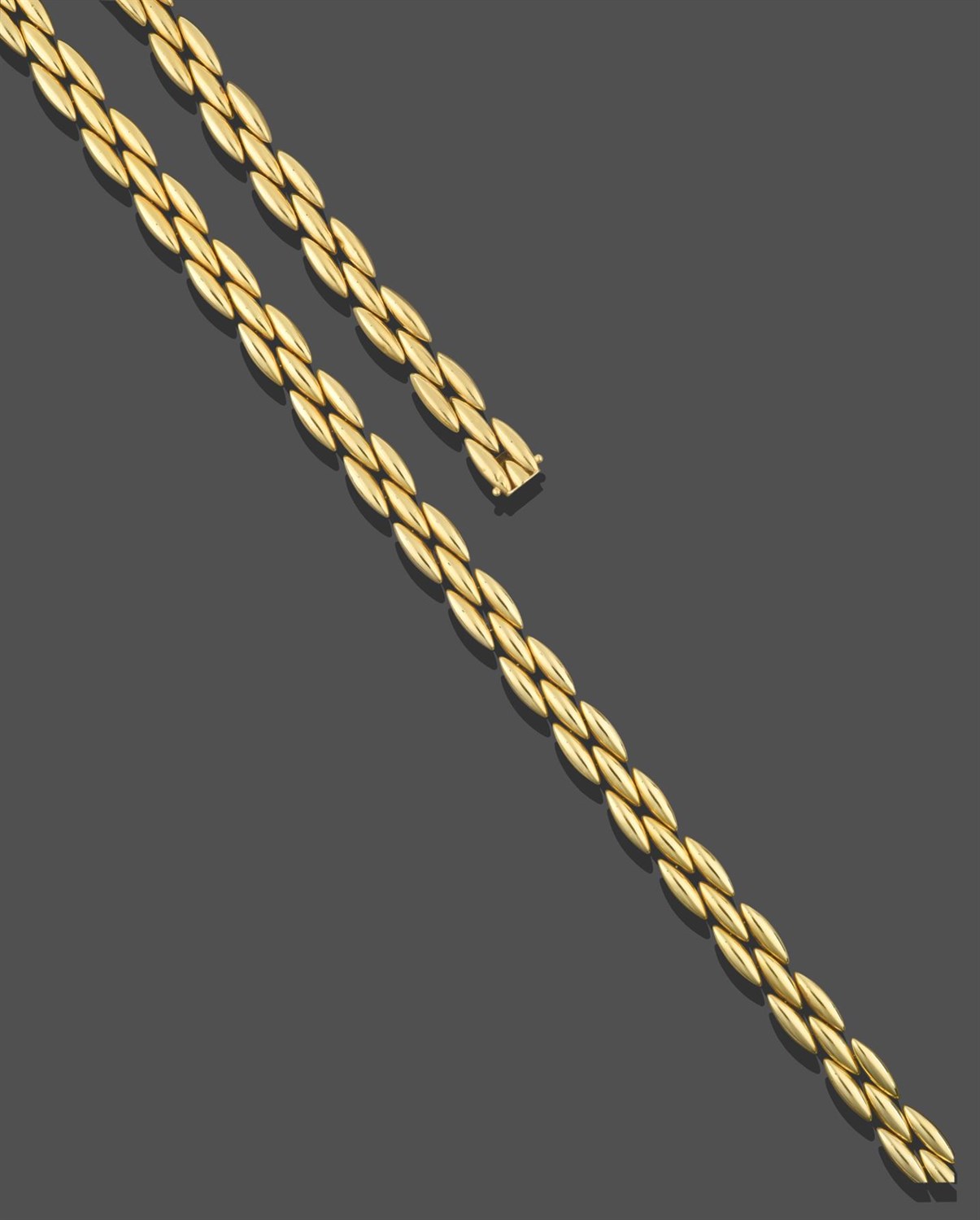 Lot 2270 - A Fancy Link Necklace and Bracelet 'Gentiane' Suite, by Cartier, formed of three rows of yellow...