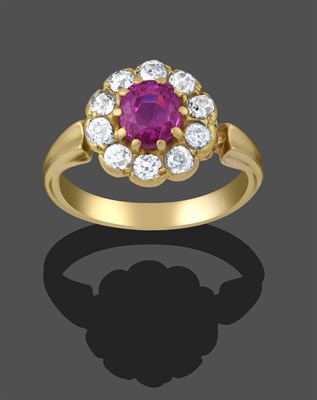 Lot 2294 - A Pink Sapphire and Diamond Cluster Ring, the round cut pink sapphire within a border of old...