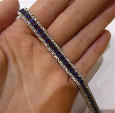 Lot 2301 - A Sapphire and Diamond Line Bracelet, formed of three rows, the central row of princess cut...