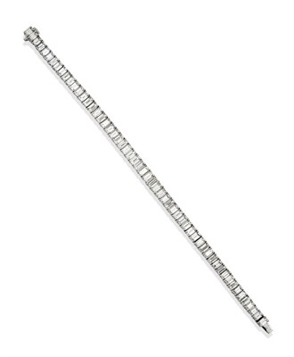 Lot 2315 - A Diamond Line Bracelet, the graduated baguette cut diamonds in white four claw settings, total...