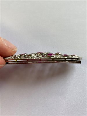 Lot 2325 - A Pink Sapphire and Diamond Brooch, circa 1925, the oval pierced plaque set throughout with...