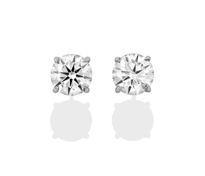 Lot 2326 - A Pair of Diamond Solitaire Earrings, the round brilliant cut diamonds in white four claw settings