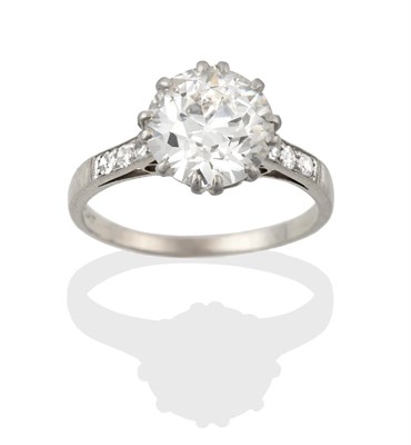 Lot 2327 - A Diamond Solitaire Ring, the round brilliant cut diamond in a claw setting, to tapered...