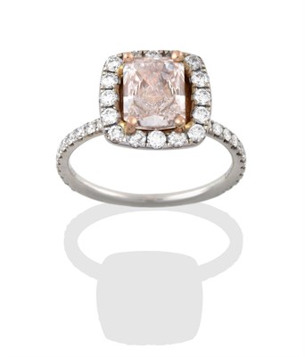 Lot 2331 - A Diamond Cluster Ring, the central fancy light brownish-pink emerald-cut diamond, in yellow...