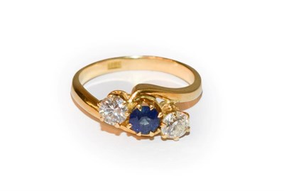 Lot 42 - A sapphire and diamond three stone twist ring, a round cut sapphire flanked by old cut diamonds, in