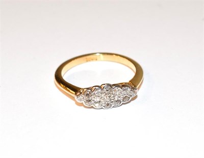 Lot 53 - A diamond cluster ring, the old cut diamonds in white claw and rubbed over settings, to a...