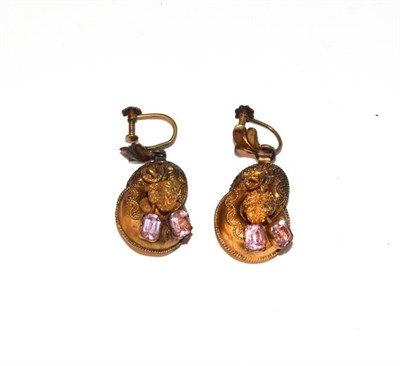 Lot 63 - A pair of drop earrings with pink stones, the yellow swirl motifs with ropetwist decoration...
