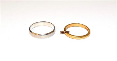 Lot 76 - An 18 carat white gold band ring, finger size P; and a 22 carat gold band ring (with pendant...