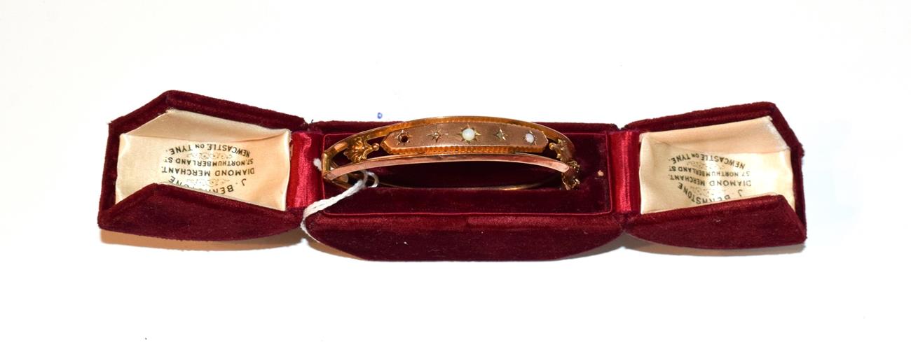 Lot 90 - A Victorian 9 carat gold opal and diamond hinged bangle, in fitted case (a.f.)