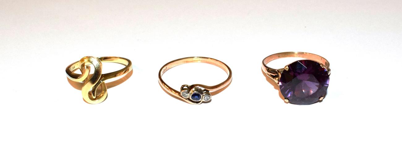 Lot 94 - A sapphire and diamond twist ring, stamped '14K', finger size U, a synthetic sapphire ring, stamped