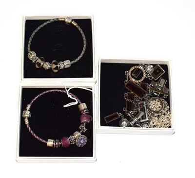 Lot 102 - Two charm bracelets, by Pandora, hung with various charms and a Swarovski crystal bracelet,...