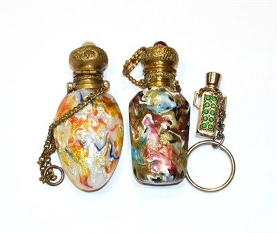 Lot 137 - Two gilt metal mounted glass scent bottles, the hinged cover on each stamped with foliage and...