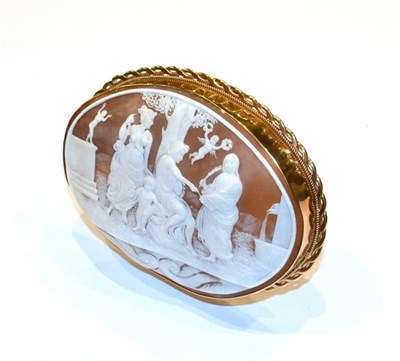 Lot 147 - A carved cameo in Elizabeth II gold stand, the stand 1976, 9ct, the cameo carved with three...