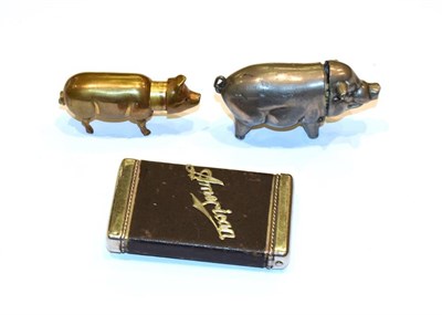 Lot 156 - Two metal vesta-cases, one modelled as a pig and one oblong, applied on one side with an...