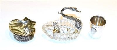 Lot 170 - A silver-mounted cut-glass ashtray in the form of a swan and with silver pipe tamper, 11cm long, an