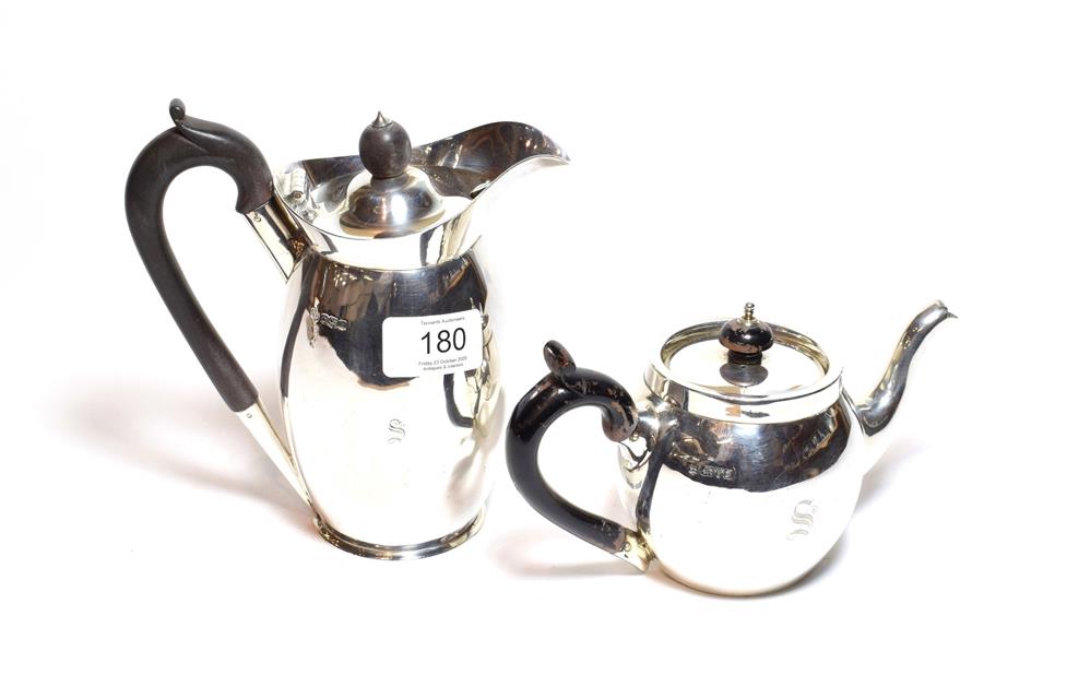 Lot 180 - An Edward VII silver teapot, by Nathan and Hayes, Chester,1906, bullet-shaped and with ebonised...