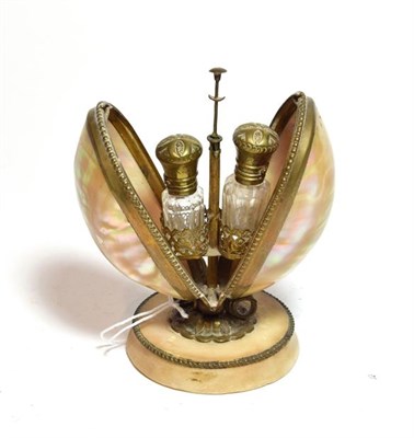 Lot 189 - A pair of Victorian brass mounted glass scent bottles, in fitted hinged shell and brass stand,...