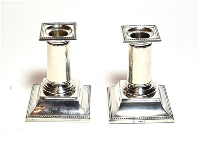 Lot 202 - A pair of Victorian silver dwarf candlesticks, by Richard Martin and Ebenezer Hall, London,...