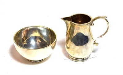 Lot 221 - A George V silver cream jug and a George V silver sugar bowl, the cream jug by G. Unite and...