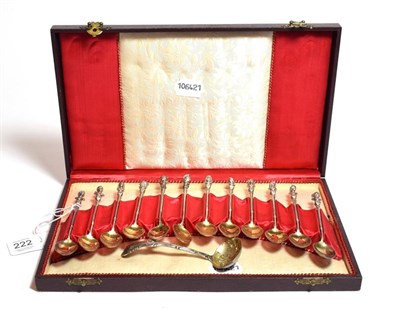 Lot 222 - A cased set of twelve gilt-metal coffee spoons, apparently unmarked, circa 1900, each with a...