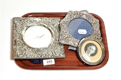 Lot 243 - Three silver photograph frames, one square the sided stamped and pierced with foliage scrolls...
