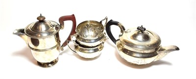 Lot 268 - A three-piece George V silver tea-service, Sheffield, 1932, each piece applied with foliage,...