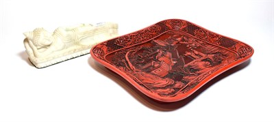 Lot 301 - A Japanese red lacquer tray carved with figures on a bridge approaching a village, together with an
