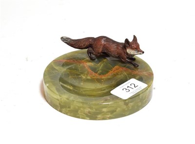 Lot 312 - An Austrian cold painted model of a fox, mounted on a green onyx circular pin dish/ ashtray