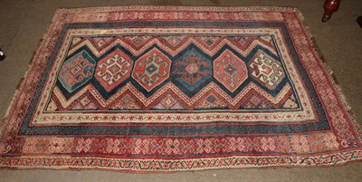 Lot 1008 - North west Persian rug, the indigo field with column of polychrome hooked guls, enclosed by...