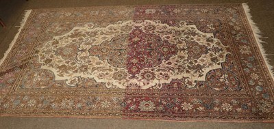 Lot 1011 - An Isfahian rug, the cream field of vines around a pole medallion, framed by spandrels and palmette