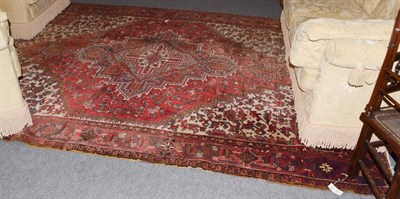 Lot 1012 - Heriz Carpet, the faded scarlet field with stepped medallion framed by spandrels and samovar...