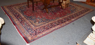 Lot 1016 - A Mashad Carpet, the central floral medallion on a red ground within spandrels and narrow...