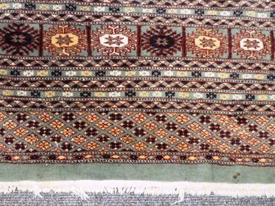 Lot 1020 - Lahore Bukhara carpet, the mint field with an all over design of Turkmen guls enclosed by...