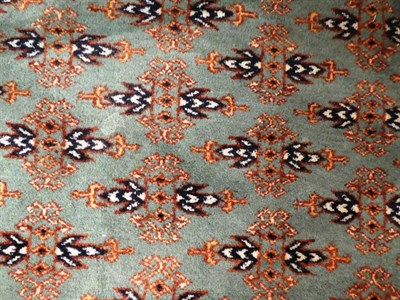 Lot 1020 - Lahore Bukhara carpet, the mint field with an all over design of Turkmen guls enclosed by...