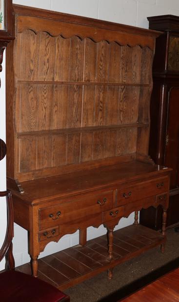 Lot 1143 - A reproduction oak dresser and rack, 143cm width by 42cm depth by 198cm height