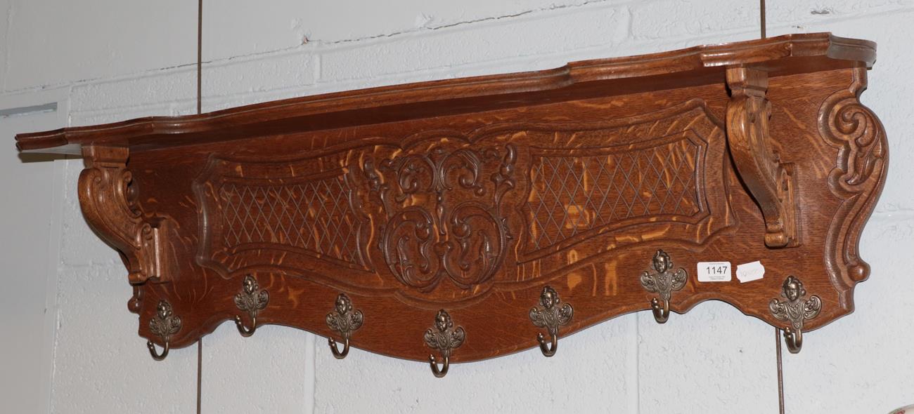 Lot 1147 - A carved oak coat rack
