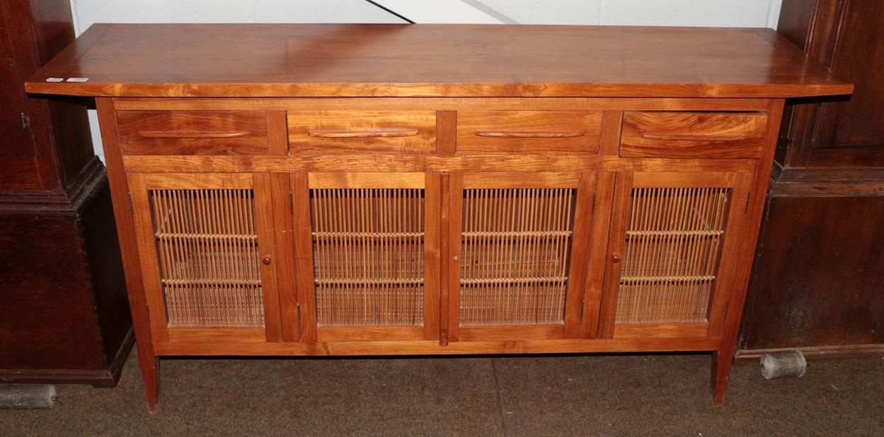 Lot 1154 - A modern sideboard comprising four top-drawers and four bamboo door panels