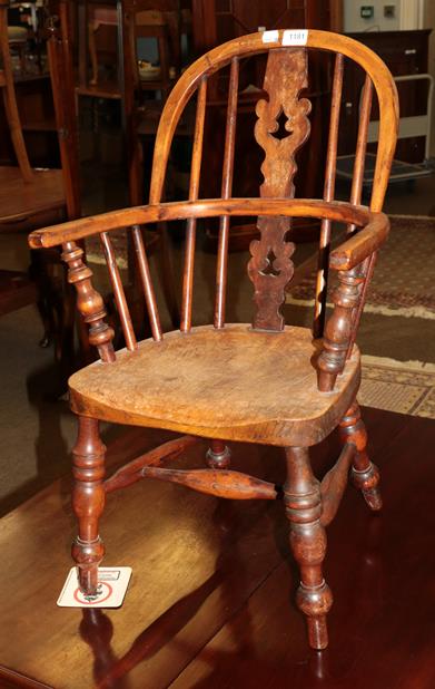 Lot 1181 - A 19th century yew child's Windsor chair
