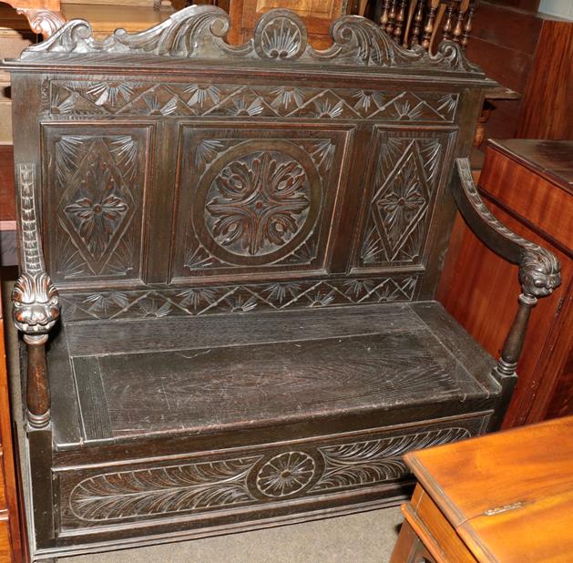 Lot 1183 - A late Victorian carved oak two-seater settle