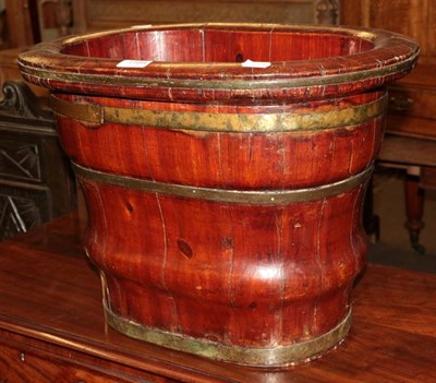 Lot 1184 - Decorative staved planter with brass bindings