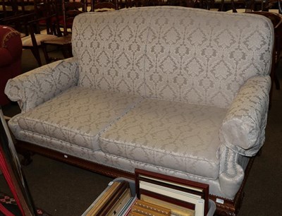 Lot 1198 - An Edwardian style two-seater sofa on claw and ball feet, upholstered in light grey damask fabric