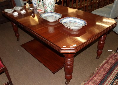 Lot 1201 - A late Victorian mahogany wind out extending dining table, on reeded legs with castors and two...