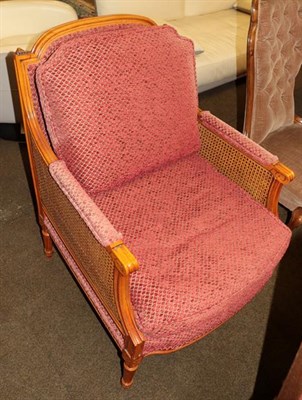 Lot 1210 - A 20th century bergere armchair, the sides with double caning